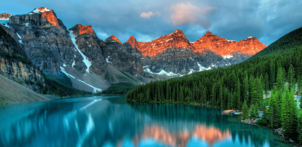 Image of a lake and forest with mountains in the background